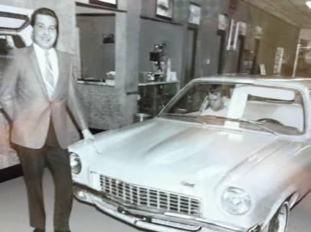 Johnny Londoff standing in front of car